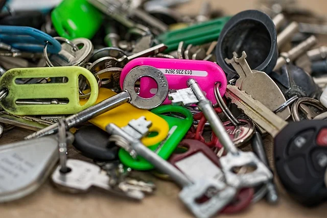 A large pile of various metal keys and colorful keytags