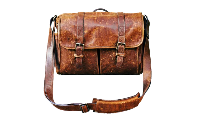 A distressed brown leather messenger bag with shoulder strap