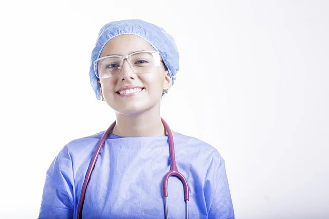 A female medical professional wearing blue scrubs and a stethoscope