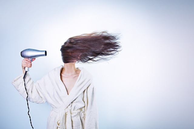 Woman applying a hair mask to her honey blonde hair