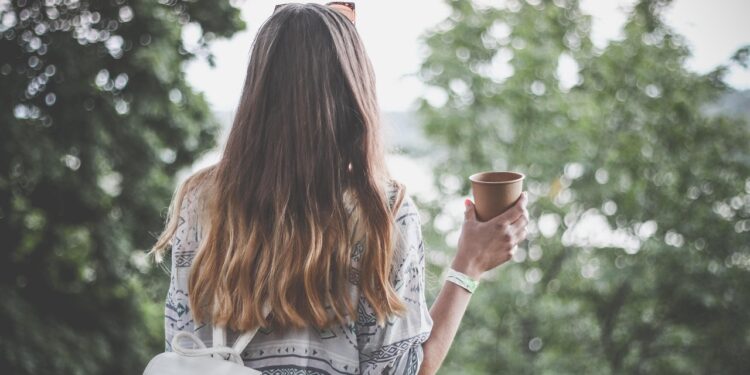 woman examining thinning hair