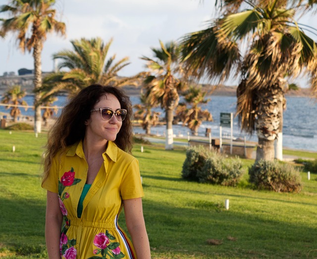 Woman smiling with natural-looking beach wave perm, showcasing texture and volume (permanent beach wave perm)