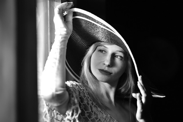 Woman wearing a wide-brimmed hat and sunglasses outdoors