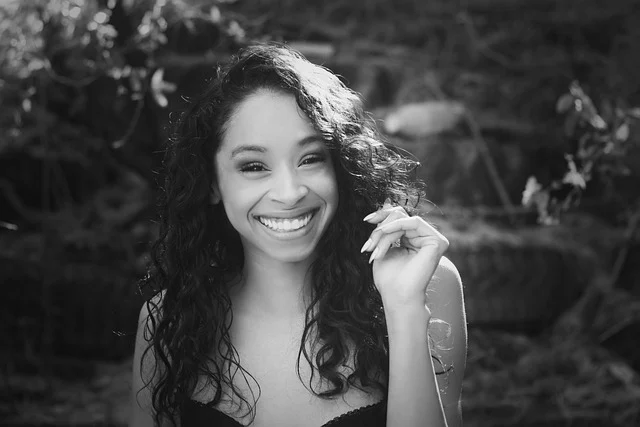 Black and white portrait of a smiling woman outdoors