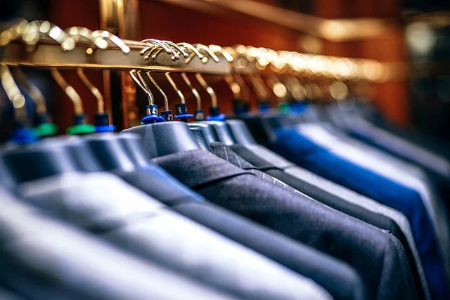 Clothes hanging on racks in a retail store