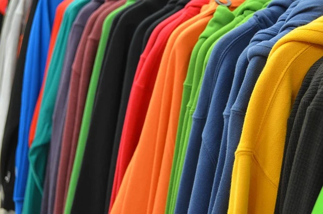 Colorful hoodies hanging on a clothes rack