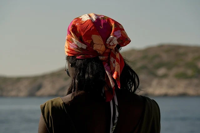 Back view of a woman wearing a colorful tied bandana