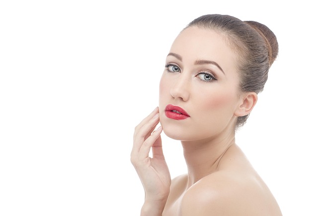 A portrait of a woman touching her smooth face skin