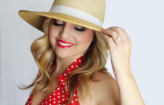 A woman wearing a sun hat and a red polka dot dress