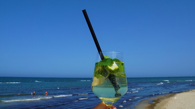 Woman enjoying a glass of water, illustrating the importance of hydration for skin health