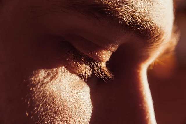 Extreme close-up of a man's facial skin and closed eye