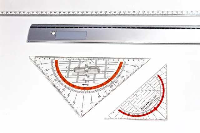 Various drafting rulers and set squares on a white background