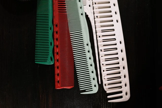 Colorful hair combs arranged on a dark surface