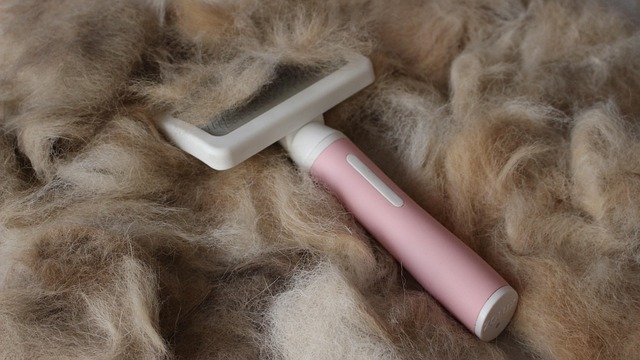 person gently brushing hair with tinsel using a wide-tooth comb, focusing on the ends