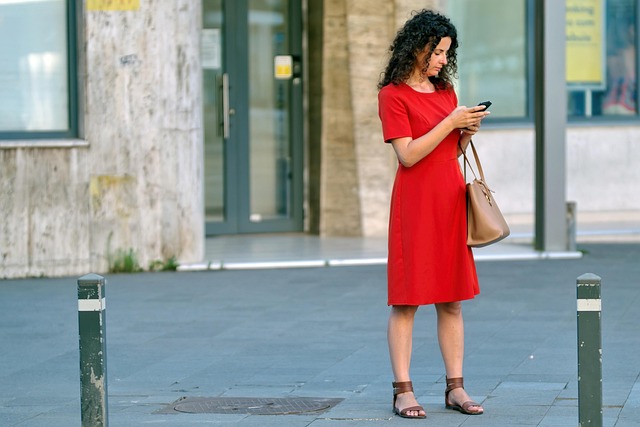 Person looking thoughtfully at their wardrobe, selecting items to mix and match