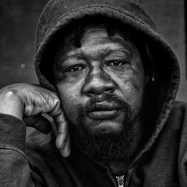 A close-up black and white portrait of a man's face
